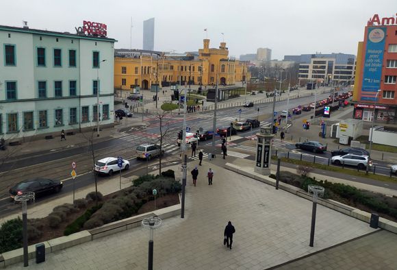 View from the hotel onto the busy street below with the railway station in the background 