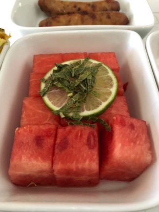 "Fresh Fruit - watermelon, lime, mint" - for prepped airline fruit, this was light, refreshing and still juicy, which is all one can reasonably expect.  To JetBlue:   the mint would taste/feel less old if it was cut in smaller pieces than the rough chiffonade shown here.