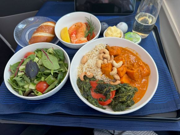 I had the Sweet Potato Chicken Masala. It was surprisingly good. 3/10 on spicy which is pretty high for a US carrier. The salmon was tasty, as was the sauce for it. The prawn was dry and chewy.