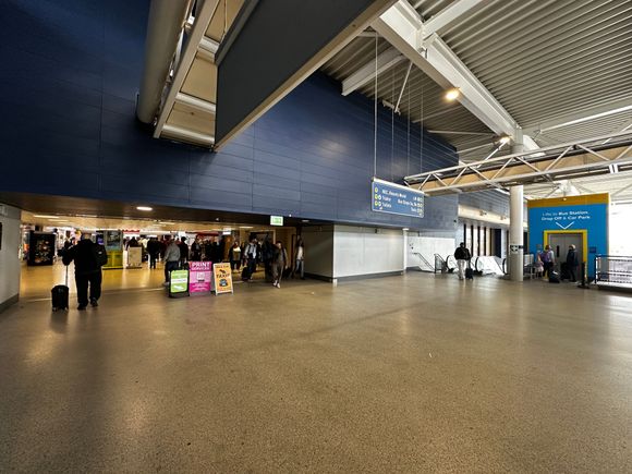 And finally on the well worn path, train station to the left, (broke) escalator down to the Uber pickup spot to the right