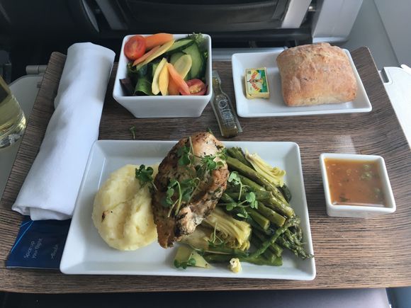 Herb roasted chicken breast with asparagus, artichoke hearts, mashed potatoes and leeks, and lemon caper sauce on side. 