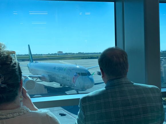 The flight arrives with Irish and US flags flying out the windows