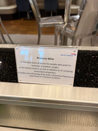 Funny sign promoting the health benefits of prosecco at BA SIN lounge