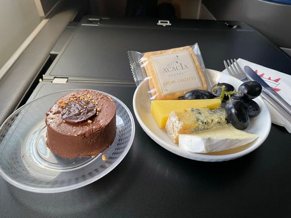 When the F/A came by after the meal service to ask if she could get me anything, I asked if they had any extra cheese plates or chocolate cake (tart?) left.  They did!