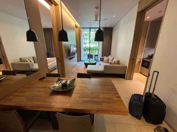 From the entryway, looking over the dining table, across the living room, and to the patio.