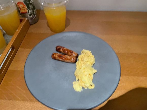 My 4 year olds scrambled eggs and chicken sausage. Might look sad but this is exactly how she ordered it — plain, nothing else touching it, and she said they were delicious 