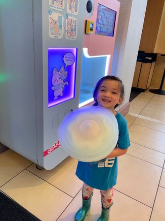 My girl with her cotton candy from the machine in the lobby 