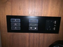 This is the console beside the bed (both sides). Light and curtain controls are clear. Power supply and two USB ports.