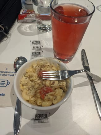 Peppered Mac and Cheese with added tomato, chicken and some Parm, along with a berry cider.  Still @ JFK.