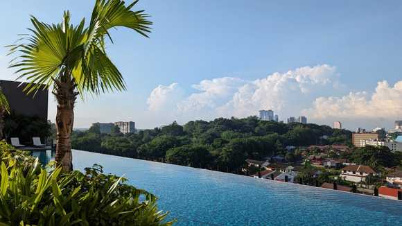 Infinity pool with views of Bukit Cina and the city