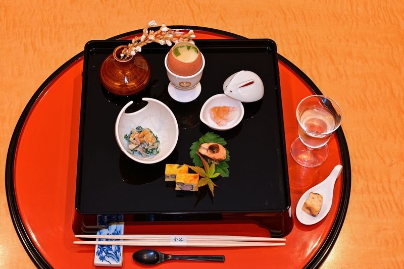 Japanese ryokan kaiseki dinner sets serve in family private room including  appetizer such as cherry blossom tofu, pork shabu hot pot and basket,  sashimi, fried and warm dishes and plum liquor Stock