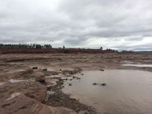 Most of the footing is more stone-like than sand-like.   Sand wouldn't stay long in one place given the force of the tides there.