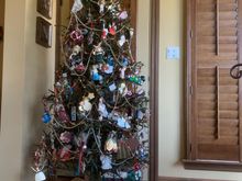 Fodors won’t let me do a vertical of this despite five tries… Anyway, she always does an angel tree and you at least get to see part of it. Can’t believe she remembers where each one of these ornaments came from. 