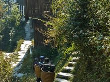 Its a 40 minute walk uphill, so locals are employed to take everyone's luggage. It was somewhat embarrassing to see seniors insisting on doing this task. Pingan was impoverished til recently and folks here are happy for the work.