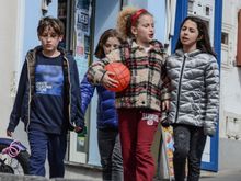 Four raggazzi headed to play calcio. Argentinian superstar Diego marradona is revered here, with tiny shrines to prove it!