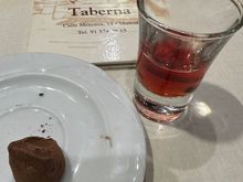 A single chocolate truffle left on the plate!  With a chupito (little shot)  of Baynes pacharán
