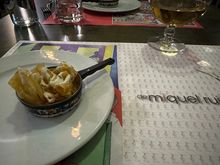 Welcome dish of house-fried potatoes with sauce of berberechos, presented in a little metal pan