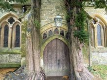 The doors into St. Edward's church flanked by two yew trees.  Some say that when Tolkien was here, he used these trees as inspiration for the Doors of Durin