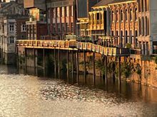 Some of those same buildings from Mickelgate Bridge later in the evening