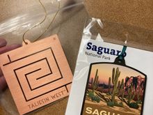 Our souvenirs from this trip. The Taliesen west symbol is inspired by petroglyph designs found on rocks on site 