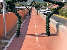 This is a walkway, nicely paved, fairly new and runs along a major road.