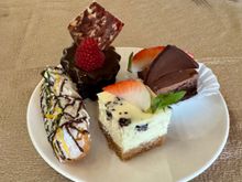 Left to right: eclair, Sticky toffee pudding, Oreo cheesecake, and some chocolate delight.