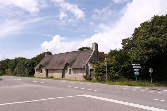 Thatched roof cottage.