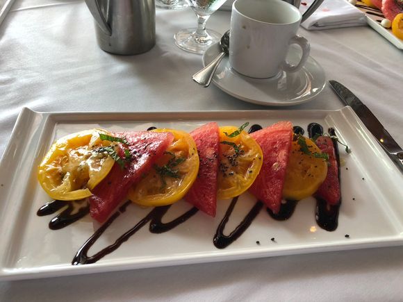 Extra yummy  appetizer of tomatoes, watermelon, cracked pepper, olive oil and balsamic reduction 