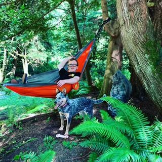 My grandson in the hammock with Libby where she always is, beside him. This is their back yard. See why my heart is in Washington State??