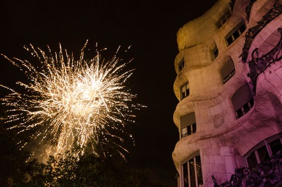 Just five shots here. There was a palpable sense of mounting excitement in the massive crowd during the hour gap between the end of the kids Correfoc and the start of the Adult version. We chatted on a wet bench with a young German engineer whose dad was from Barcelona. The second that the above fireworks signaled 'the start' and illuminated Gaudi's most famous apartment, the above wavy 'La Pedrera', an ocean of giddy people swept us away from that bench. 