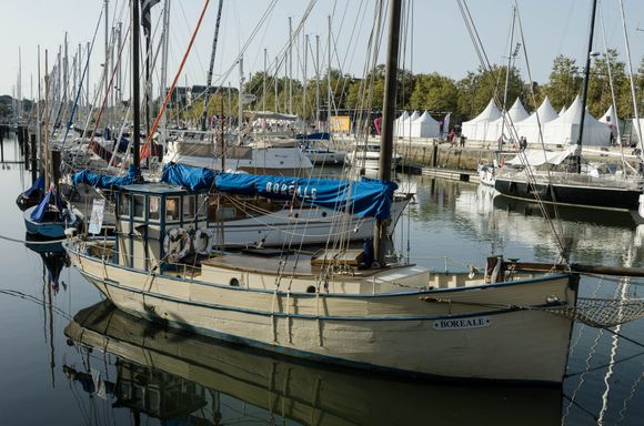 One weekend, there was an eco-fest. Seen in the distance, the fest's collection of white tent display-booth kiosks. The heritage boat shown here was used for tourist cruises in the Gulf of Morbihan.