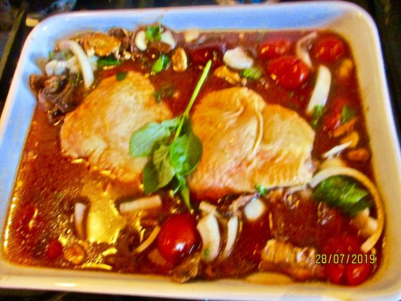chicken thighs baked with fresh tomatoes and herbs from the garden
