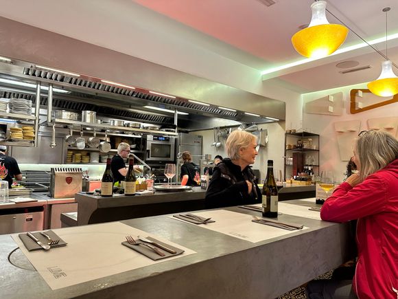 Seating is at a long, narrow table, on high stools.  There are a couple of tables for two persons.