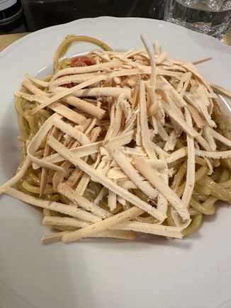 Spaghetti alle carrettiera, with pistachio pesto, cherry tomatoes, capers, and topped with the long strips of baked ricotta that you see on the top of the pasta....very good but not repeatable.