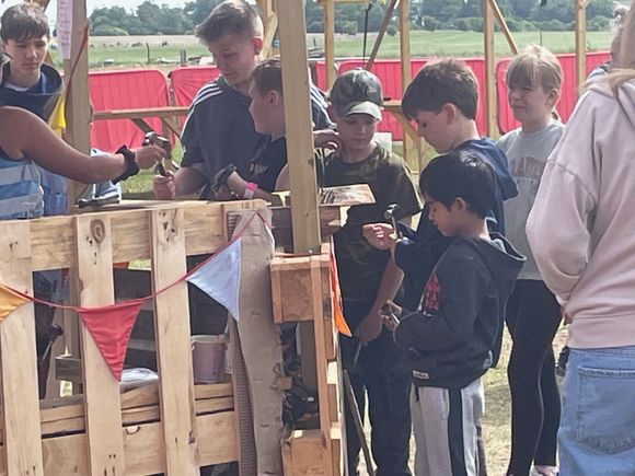 Someone is handing out tools, a hammer here, a saw there or a screwdriver.