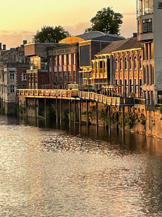 Some of those same buildings from Mickelgate Bridge later in the evening