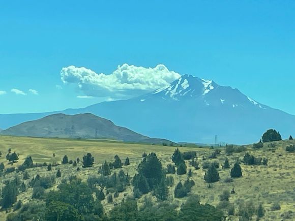 Picture looking back on Mt. Shasta with one of it's little cloud friends.  It's not erupting!