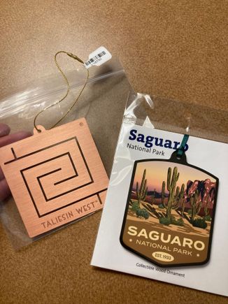Our souvenirs from this trip. The Taliesen west symbol is inspired by petroglyph designs found on rocks on site 
