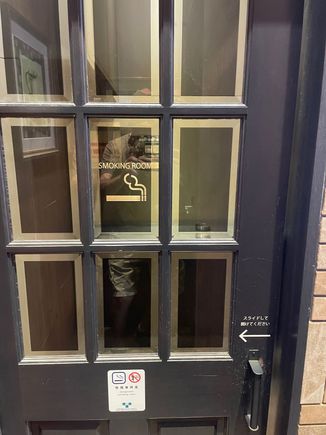 This is a smoking room.  We've seen a number of these. This one was just across from the bathrooms.  Slide the door, step inside, and light 'em if you got 'em.