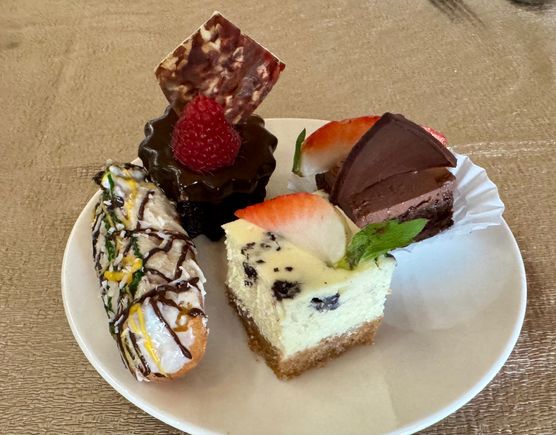 Left to right: eclair, Sticky toffee pudding, Oreo cheesecake, and some chocolate delight.