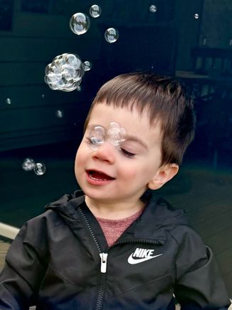 The water pistol that makes bubbles is his new favorite toy!