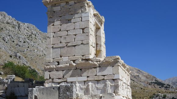 The famous Monument for a Patron of the city. 
Are the figures on the base female members of his family?