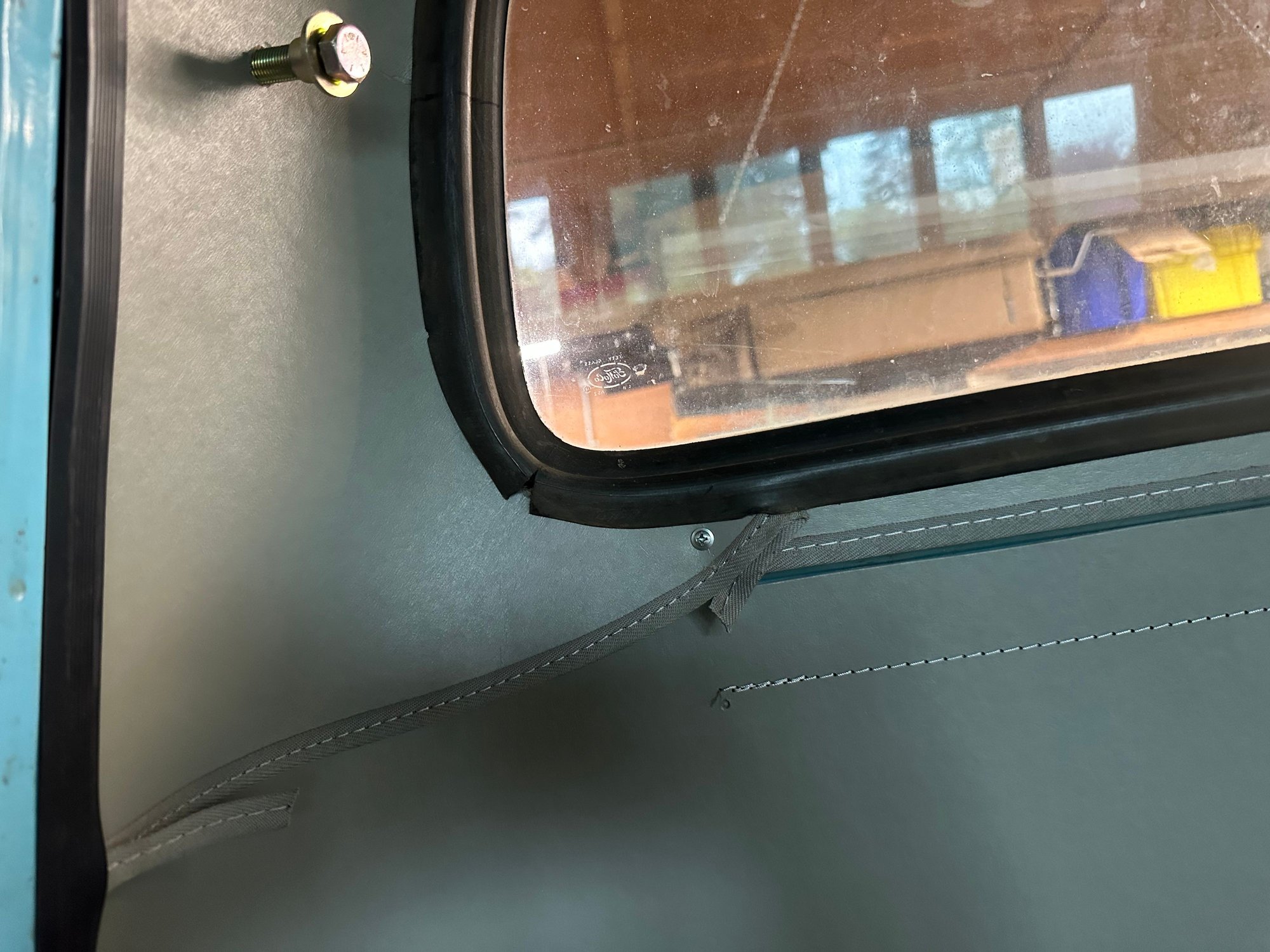 Screw in place holding the headliner and filler panel in place. 