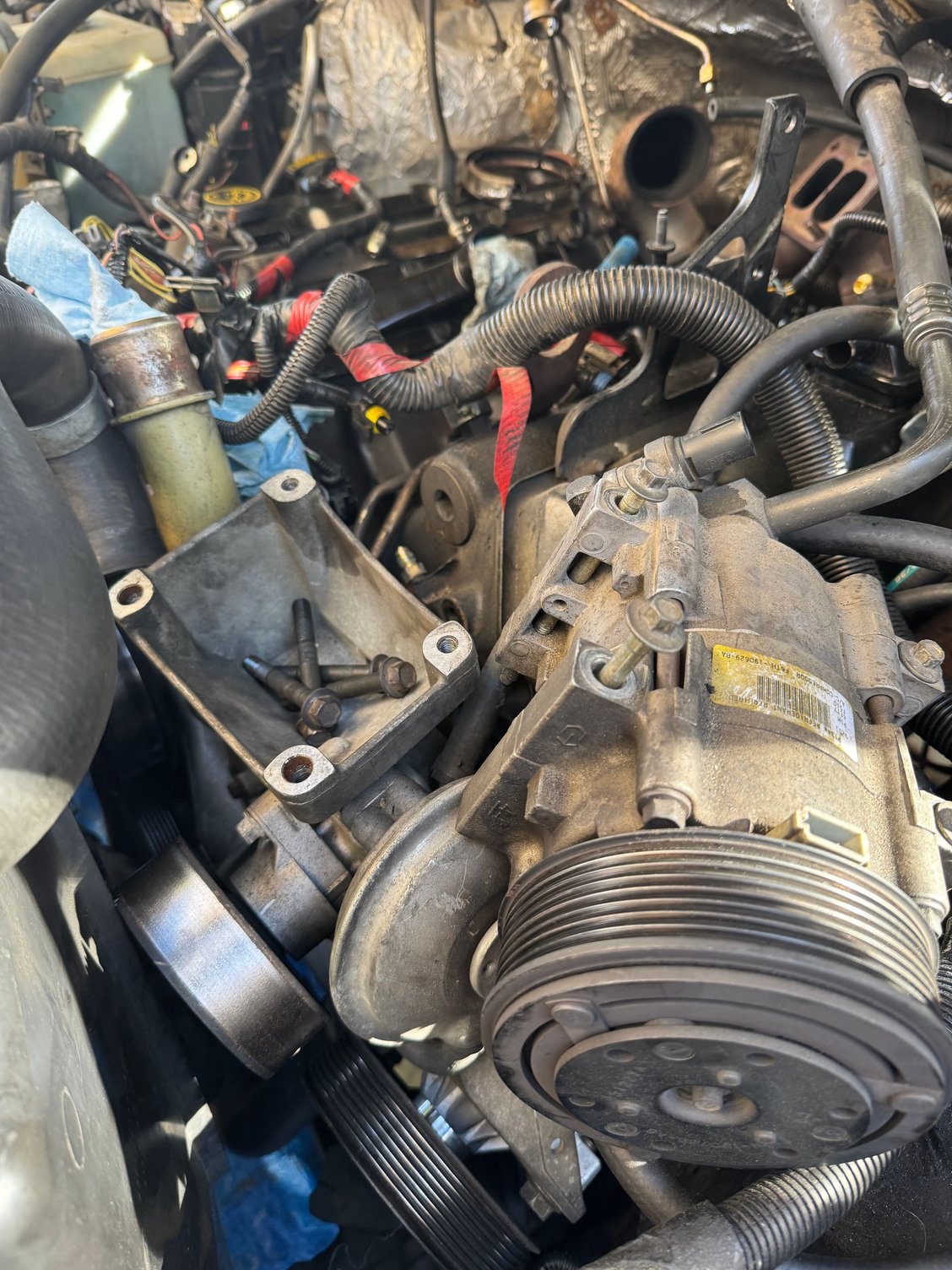 AC bracket removed to run the fuel lines