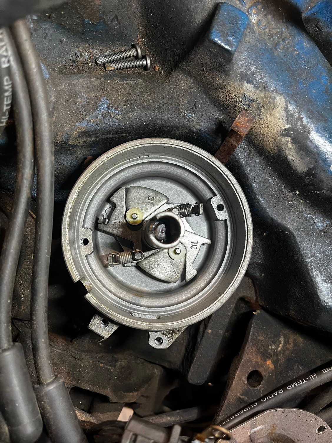 Before.  I used a mr gasket 925d spring in place of the heavy I had, and a bushing from an HEI kit and a little tweaking of the pin to dial her down from 32* mechanical advance to 20*.  Lubed everything while in there.