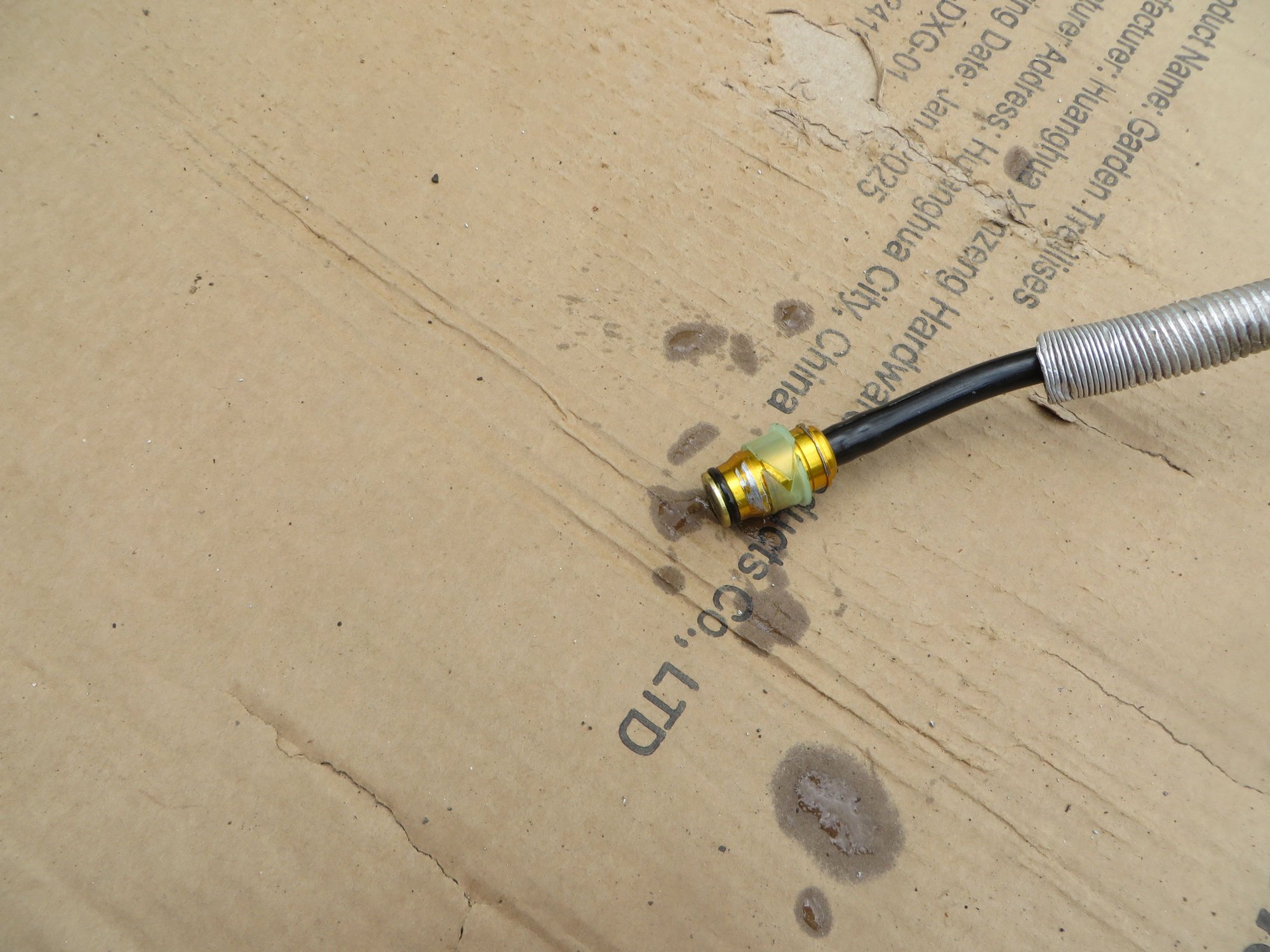 Master cylinder fitting after exercising the master cylinder plunger rod to test the check valve seal. It produced a spray from the check valve confirming that the o-ring was supposed to seal this check valve.