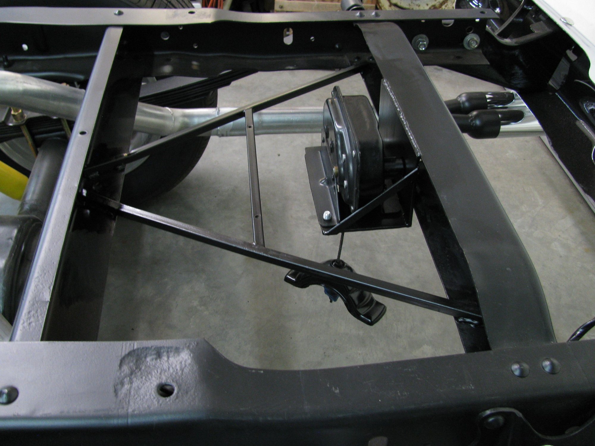 Putting a new model spare tire hoist under 66 F100 Ford Truck