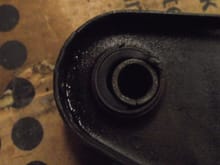 Old support arm showing wear of bushing rubber.