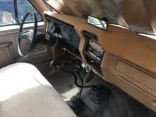 Interior as of late 2018 with custom cheap dash wrap, 1984 bronco shift knob, aftermarket tach, oil pressure, and temp gauges; and placeholder radio.