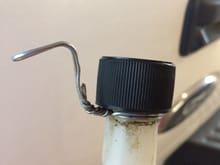 Wrap some stainless wire around a Sta-Bil bottle and form a hook.